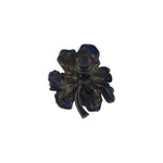 Navy blue iris-shaped brooch by BEGÜM KHAN featuring intricate metalwork and elegant design.
