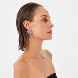 Model wearing BEGÜM KHAN IRIS earrings with platinum and crystal details, showcasing elegant dangle earrings.
