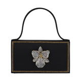 Gold orchid-themed BEGÜM KHAN bag with floral design, featuring a structured shape and elegant details.